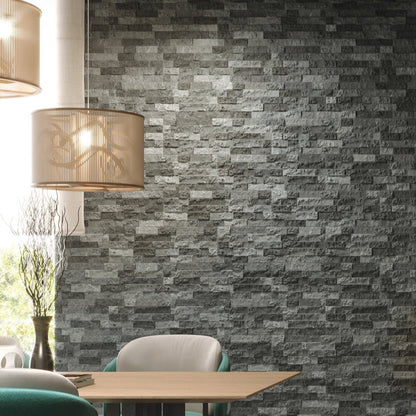 Modern interior with stone walls, tables, and chairs.