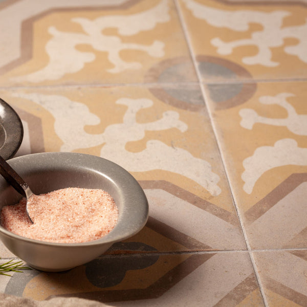Close-up of vintage-style tile featuring yellow and blue interlocking motifs