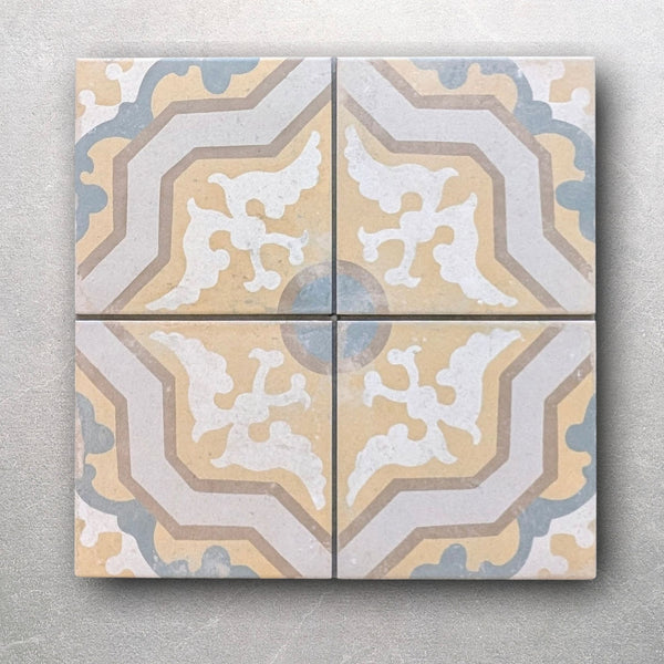 Front view of heritage geometric wall and floor tile in mustard yellow, soft blue, and ivory
