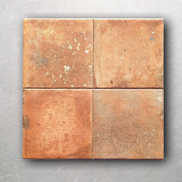 Front view of rustic terracotta tile with handmade-look texture and color variation