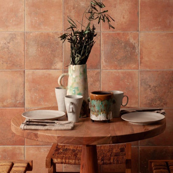 Farmhouse interior or patio space featuring handmade-look terracotta tile floor